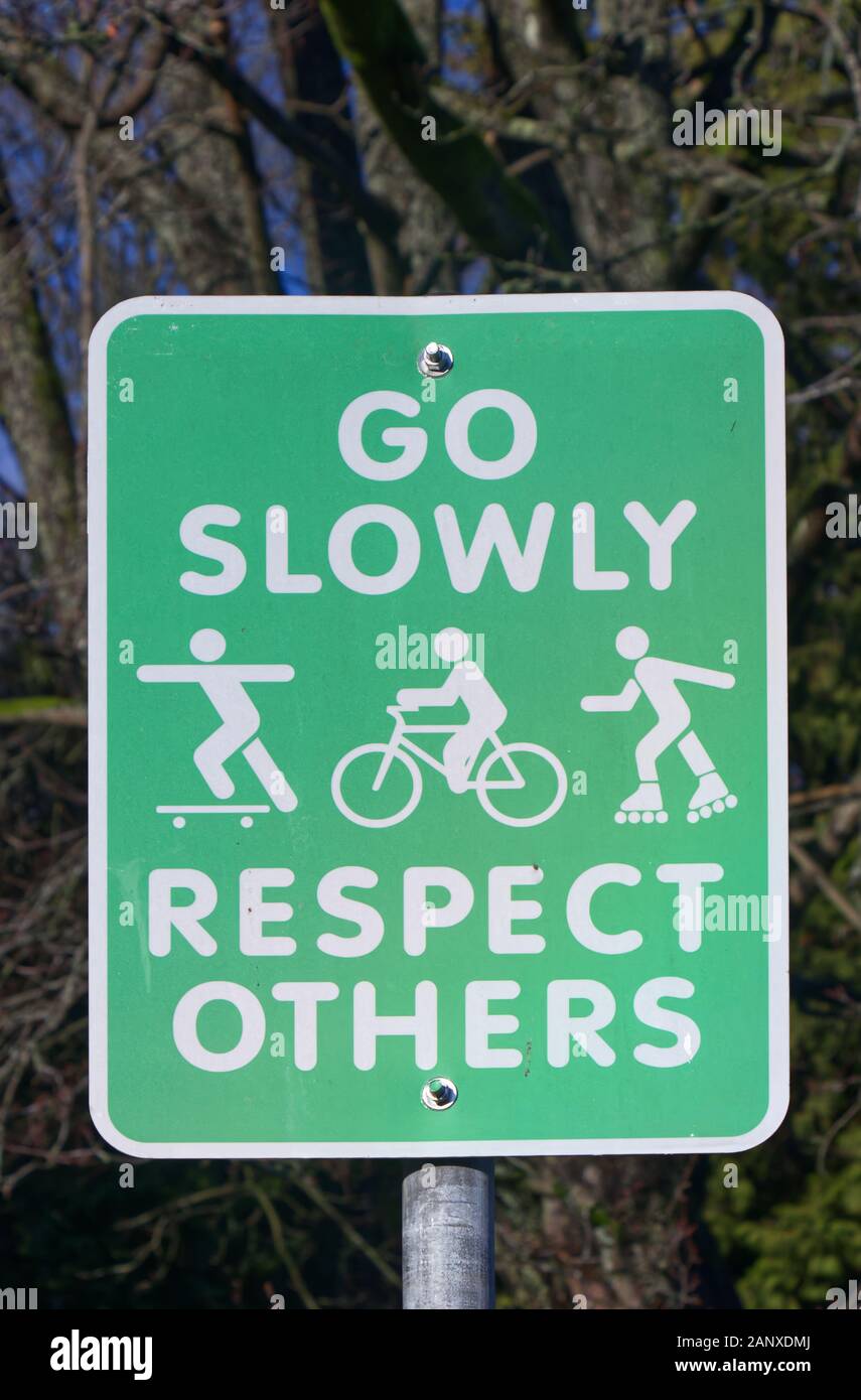 A View of green road sign 'Go slowly,  respect others' in Vancouver Stock Photo