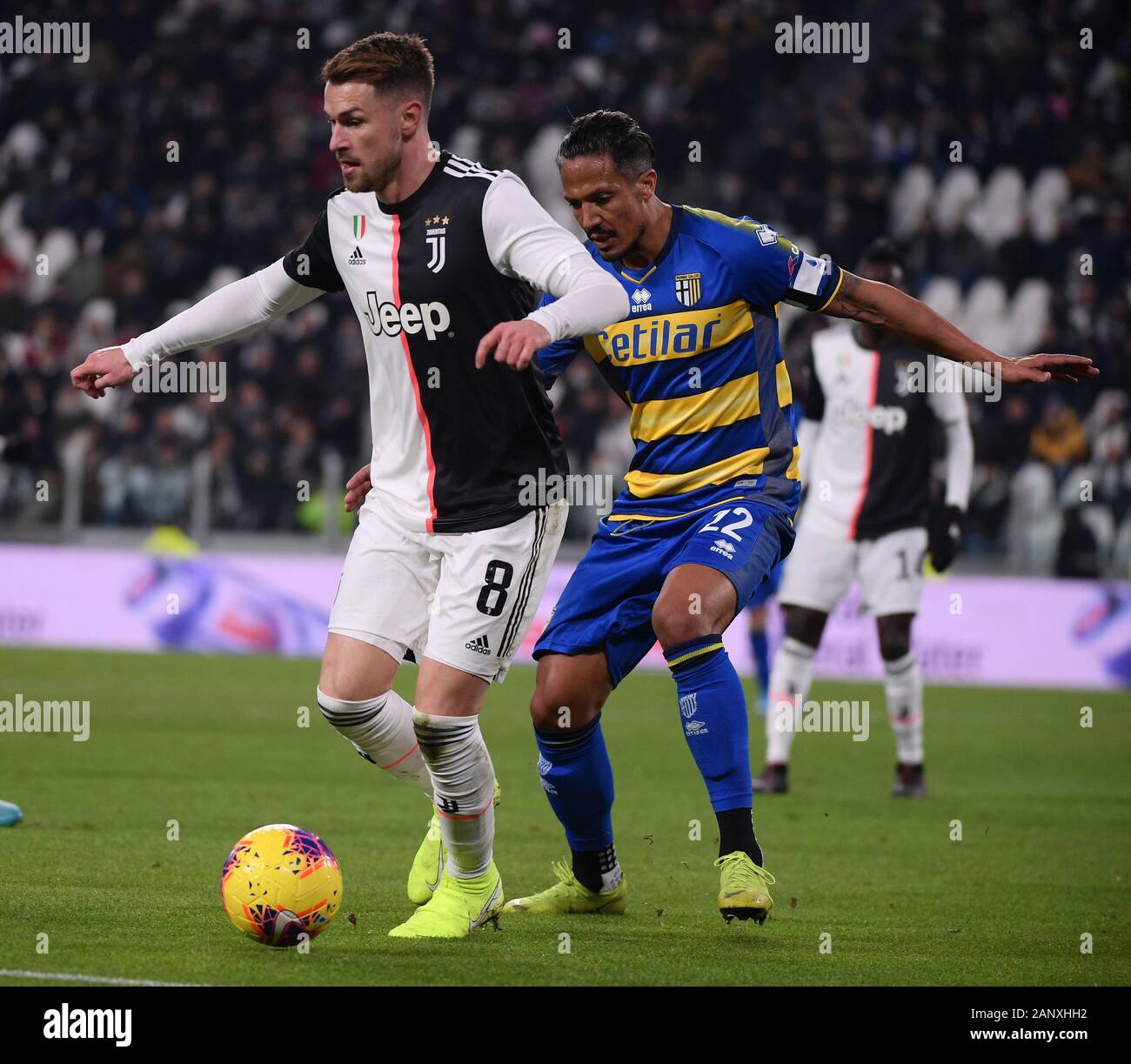 Turin, Italy. 19th Jan, 2020. FC Juventus' Aaron Ramsey (L) vies with Parma's Bruno Alves during a Serie A football match between FC Juventus and Parma in Turin, Italy, Jan. 19, 2020. Credit: Alberto Lingria/Xinhua/Alamy Live News Stock Photo