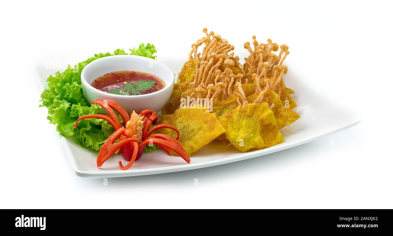 Crispy Wonton Wrapped with Golden Needles Mushrooms Served Sweet Chili Sauce Thai Food Asian Appetizer dish decorate with carved chili vegetables side Stock Photo