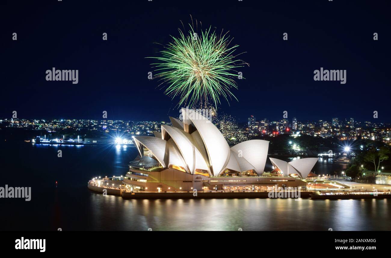 SYDNEY, AUSTRALIA - MARCH 8, 2018 - A big green ball of fireworks bursts against the night sky over the Sydney Opera House Stock Photo