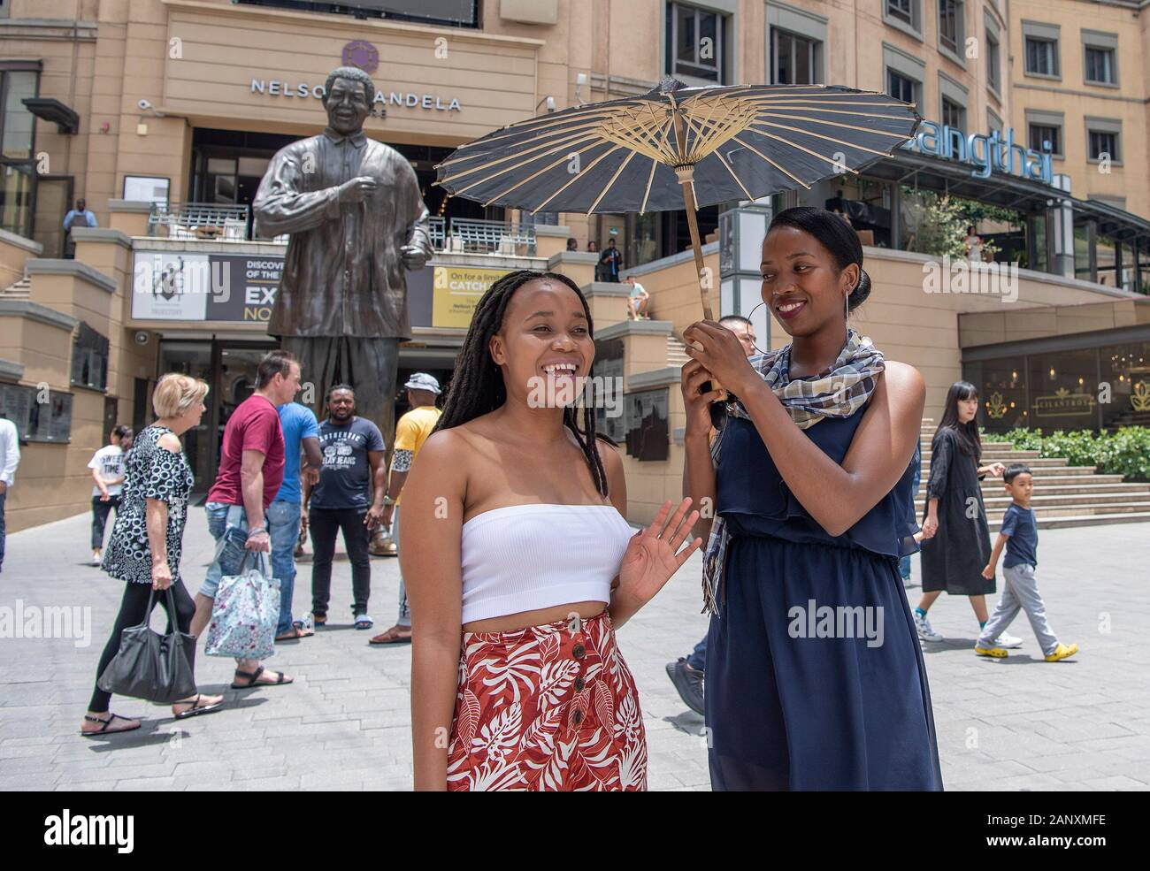 Johannesburg, South Africa. 19th Jan, 2020. Locals holding a Chinese traditional oil-paper umbrella pose for photos during celebrations for the upcoming Chinese Lunar New Year in Johannesburg, South Africa, Jan. 19, 2020. Hundreds of Chinese and South Africans of all ages from different backgrounds gathered together at Nelson Mandela Square in Johannesburg on Sunday to celebrate Chinese Lunar New Year. A number of performers based both in China and South Africa entertained the attendees with music and dance. Credit: Chen Cheng/Xinhua/Alamy Live News Stock Photo