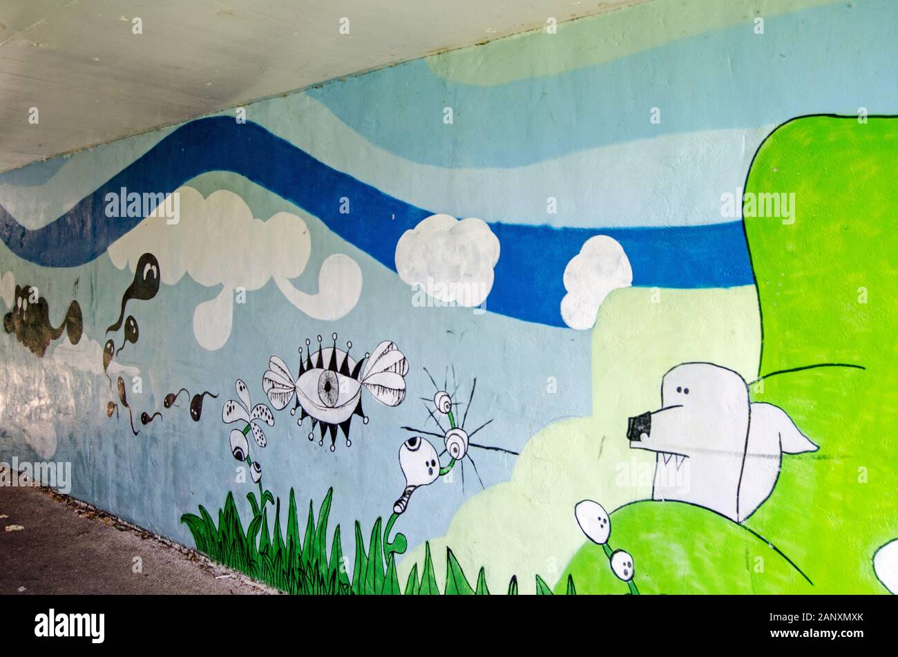 Basingstoke, UK - July 24, 2019: Mural of a fantasy dreamscape decorating the pedestrian subway beneath Viables Roundabout in Basingstoke. Stock Photo