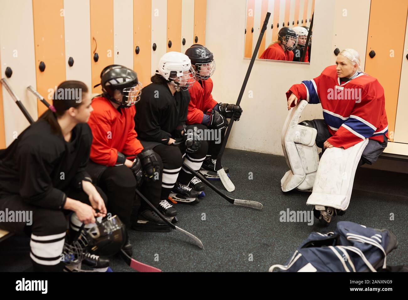 Portrait of female hockey team captain giving motivational pep talk in