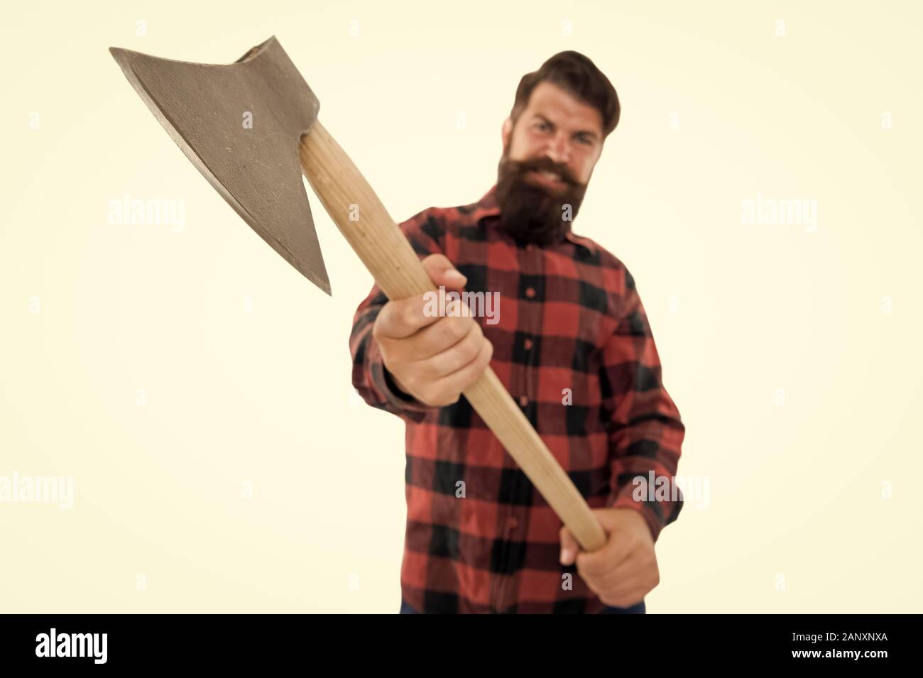 Chop it. Axe selective focus. Bearded man hold large axe handle