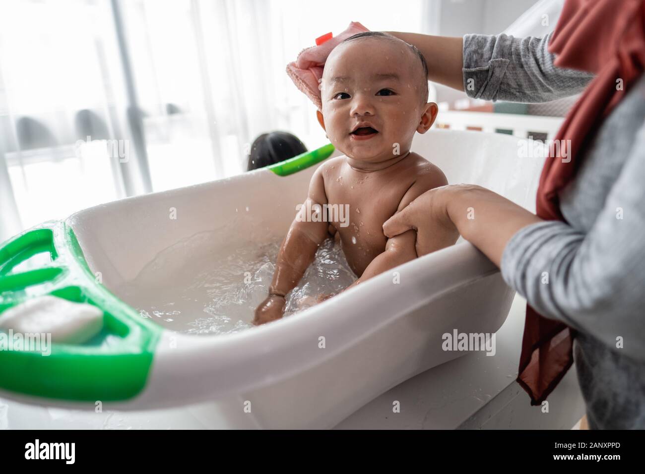 happy baby taking a bath with mother Stock Photo Alamy