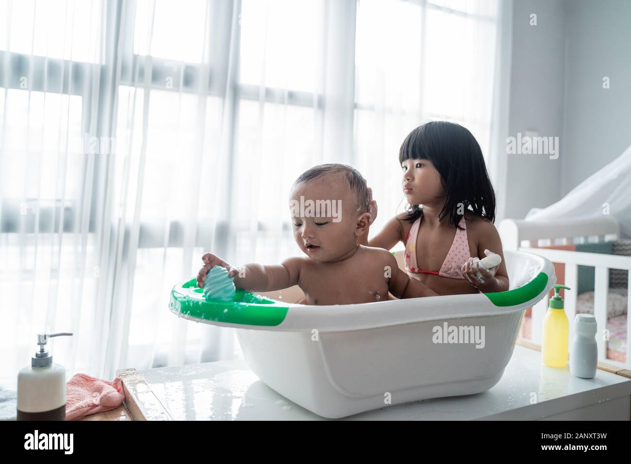 child sibling taking bath together at home Stock Photo Alamy
