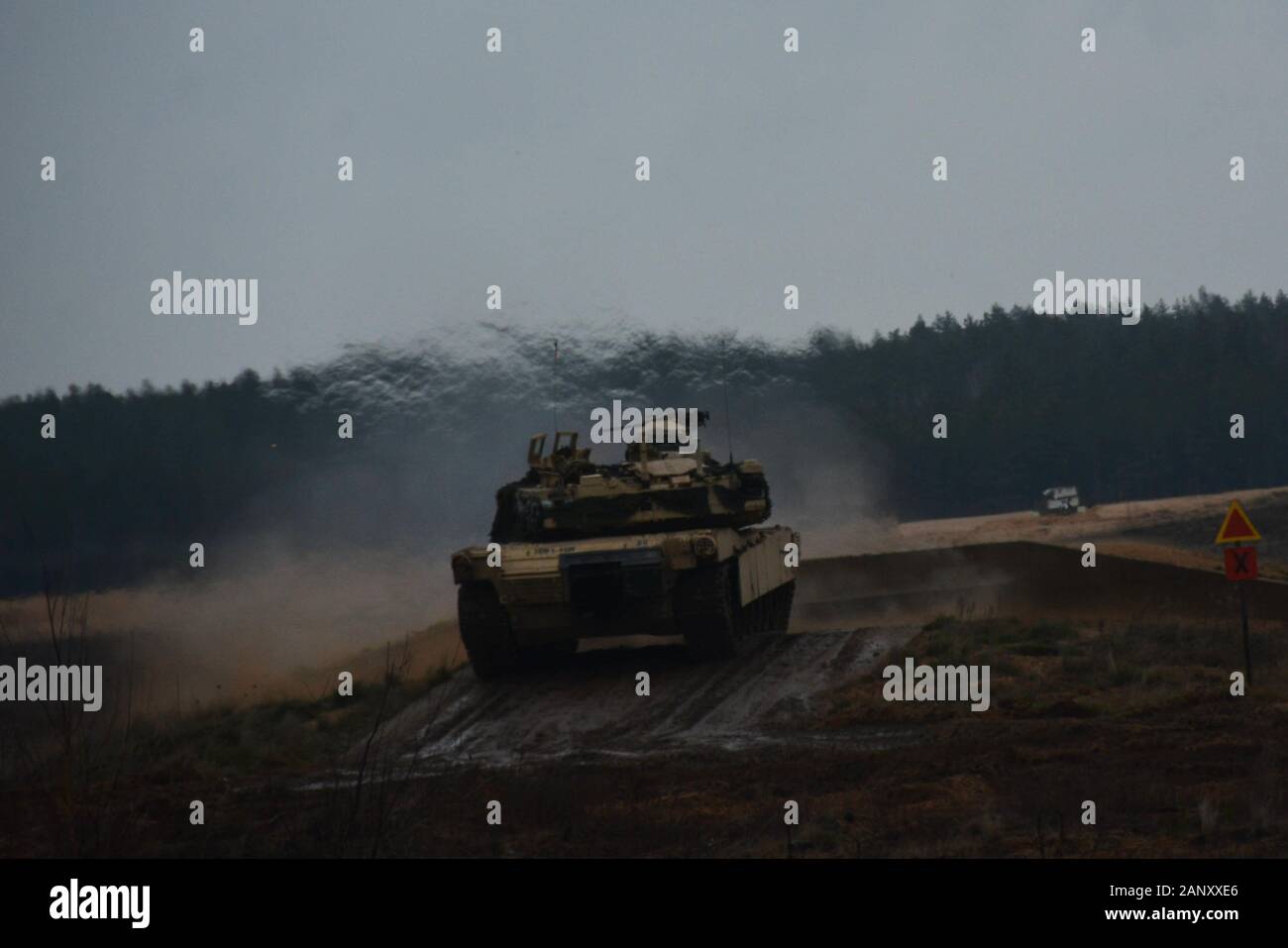 An M1A2 Abrams tank fires toward the enemy contact point as part of live fire range training on January 14, 2020, in Pabradé, Lithuania. Soldiers from the 1st Battalion, 9th Cavalry Regiment, 2nd Armored Brigade Combat Team, 1st Cavalry Division ‘Headhunters’, participated in the live fire exercise in order to hone their skills at reacting to enemy fire.   (U.S. Army National Guard Photo by Staff Sgt. Scott D. Longstreet) Stock Photo