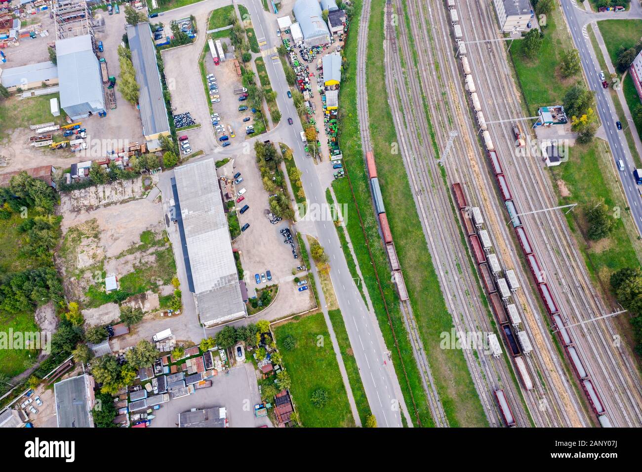 railway tracks with trains going in industrial area. aerial photo from flying drone Stock Photo