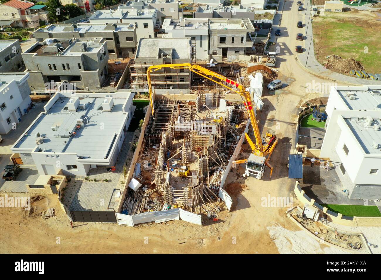 Concrete pump working on a large foundation pour at a new Suburban development site, Aerial view. Stock Photo