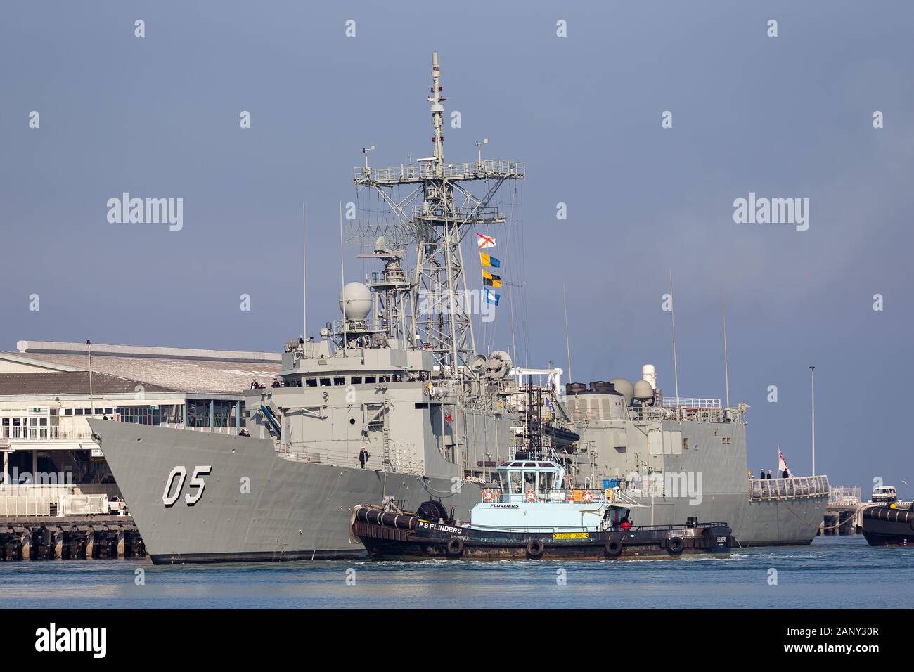 HMAS Melbourne (FFG 05) Adelaide-class guided-missile frigate of the Royal Australian Navy docking at Station Pier in Melbourne with the assistance of Stock Photo