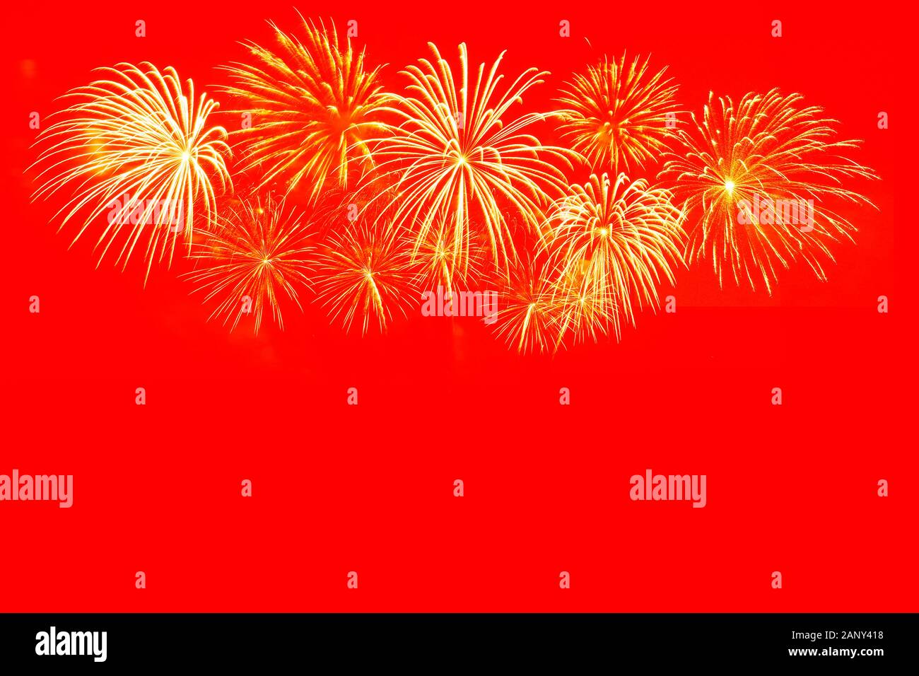 Gold fireworks celebration on red background for Chinese new year celebration. Stock Photo