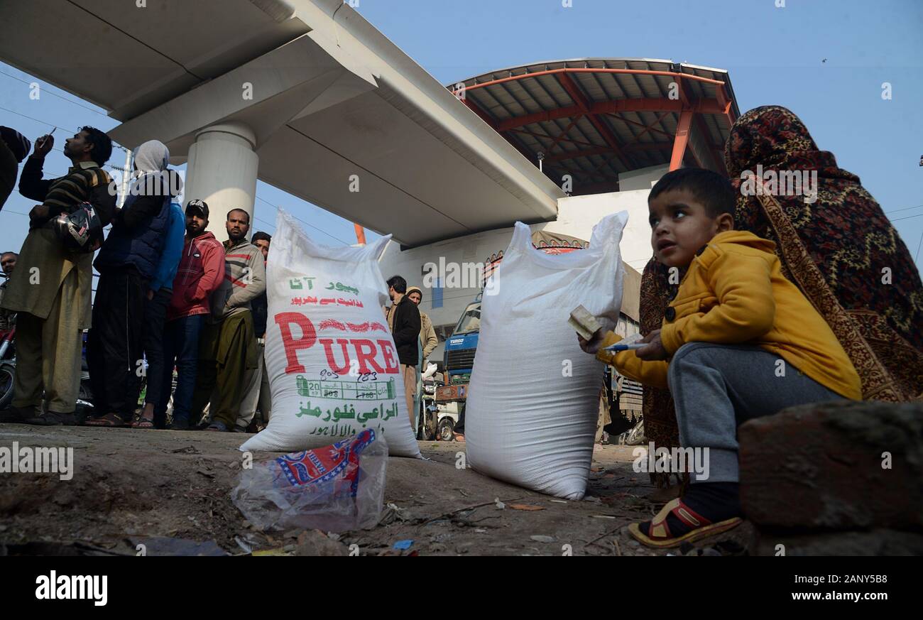 Lahore, Pakistan. 19th Jan, 2020. Pakistani People stand in queue as buying flour sacks from flour mill truck while Atta Chakki Association announced the price hike of flour, Punjab government selling flour with fix 20 kg sack Rs-790 at Baghan Pura area in Lahore. Another crisis in the form of wheat flour shortage has hit people across the country while the government and other stakeholders pass on the buck to one another instead of taking the responsibility and finding a remedy, in federal capital. (Photo by Rana Sajid Hussain/Pacific Press) Credit: Pacific Press Agency/Alamy Live News Stock Photo