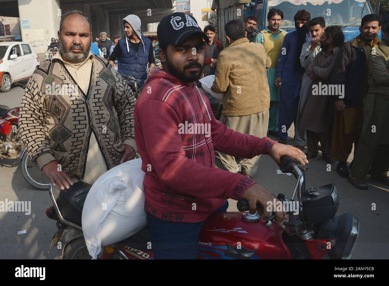 Lahore, Pakistan. 19th Jan, 2020. Pakistani People stand in queue as buying flour sacks from flour mill truck while Atta Chakki Association announced the price hike of flour, Punjab government selling flour with fix 20 kg sack Rs-790 at Baghan Pura area in Lahore. Another crisis in the form of wheat flour shortage has hit people across the country while the government and other stakeholders pass on the buck to one another instead of taking the responsibility and finding a remedy, in federal capital. (Photo by Rana Sajid Hussain/Pacific Press) Credit: Pacific Press Agency/Alamy Live News Stock Photo