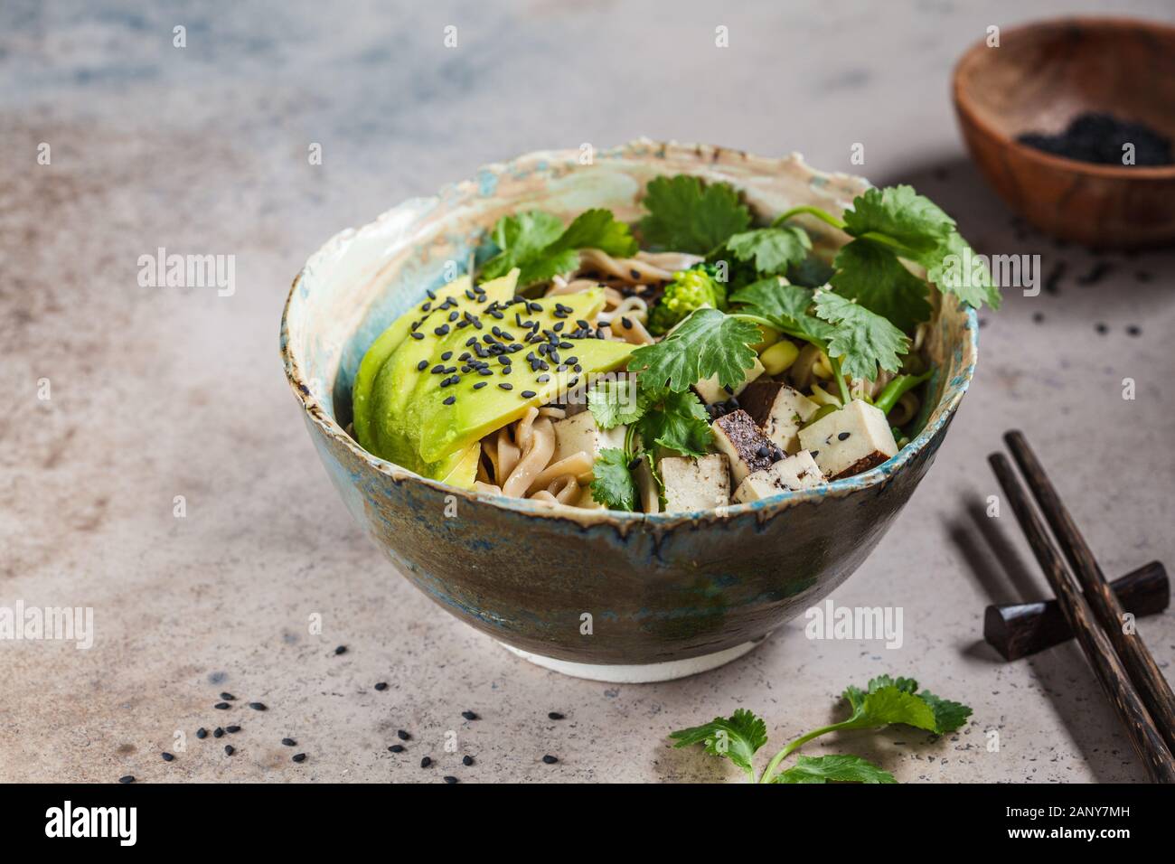 Buckwheat noodles soba with tofu, broccoli, avocado, seedlings and