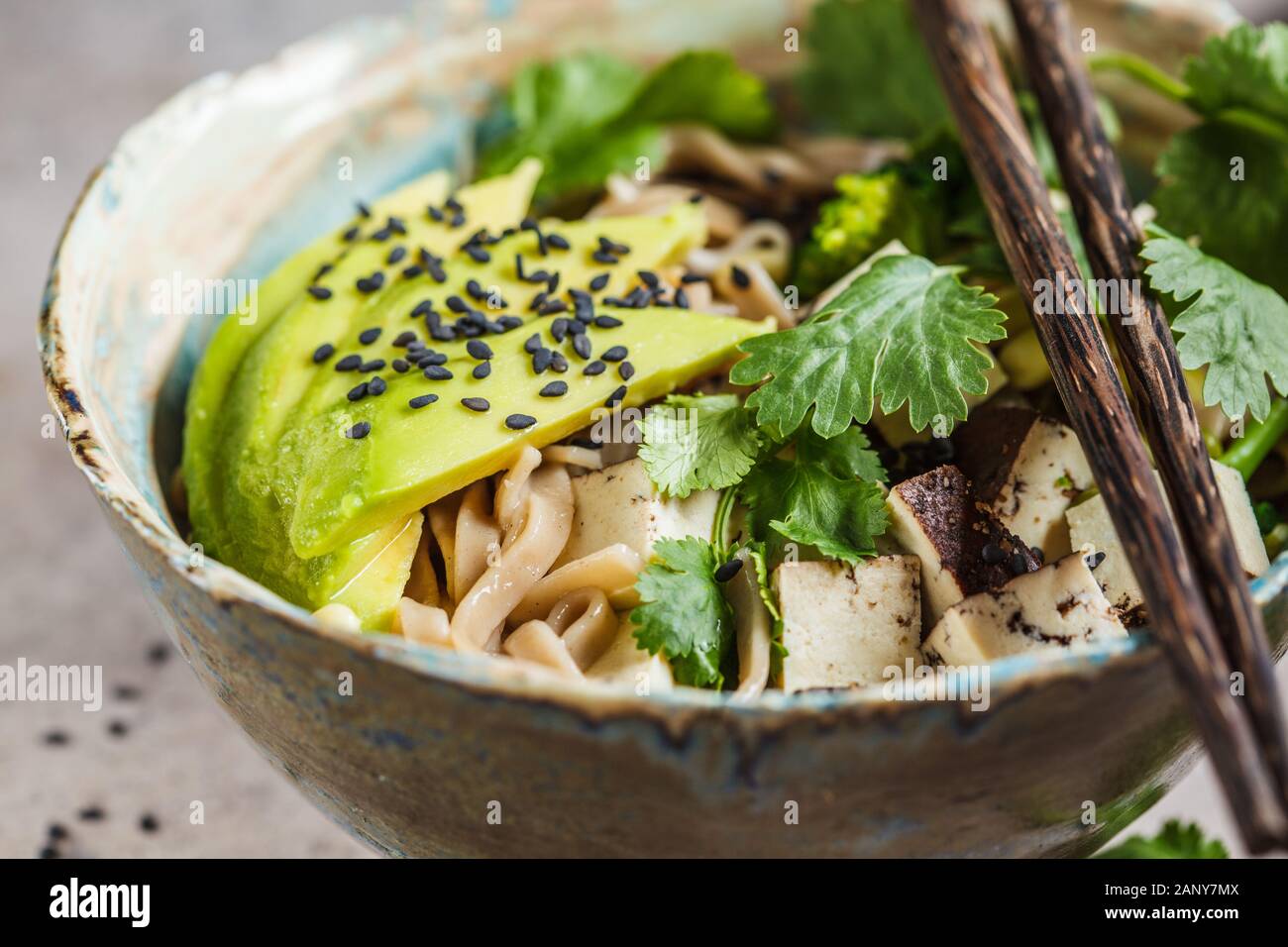 Buckwheat noodles soba with tofu, broccoli, avocado, seedlings and