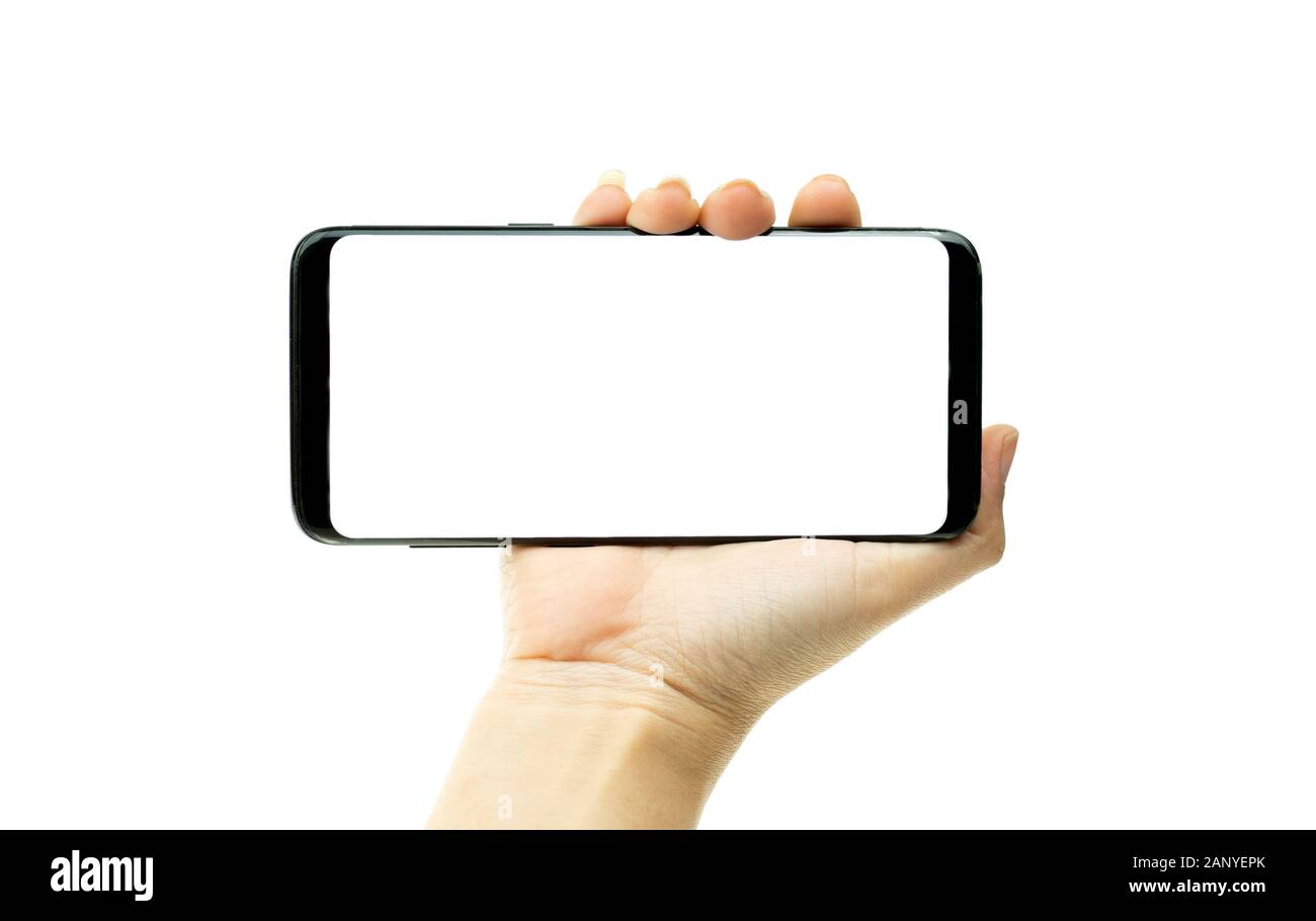 Woman hand holding black mobile phone with white screen at the background, smartphone blank screen Stock Photo