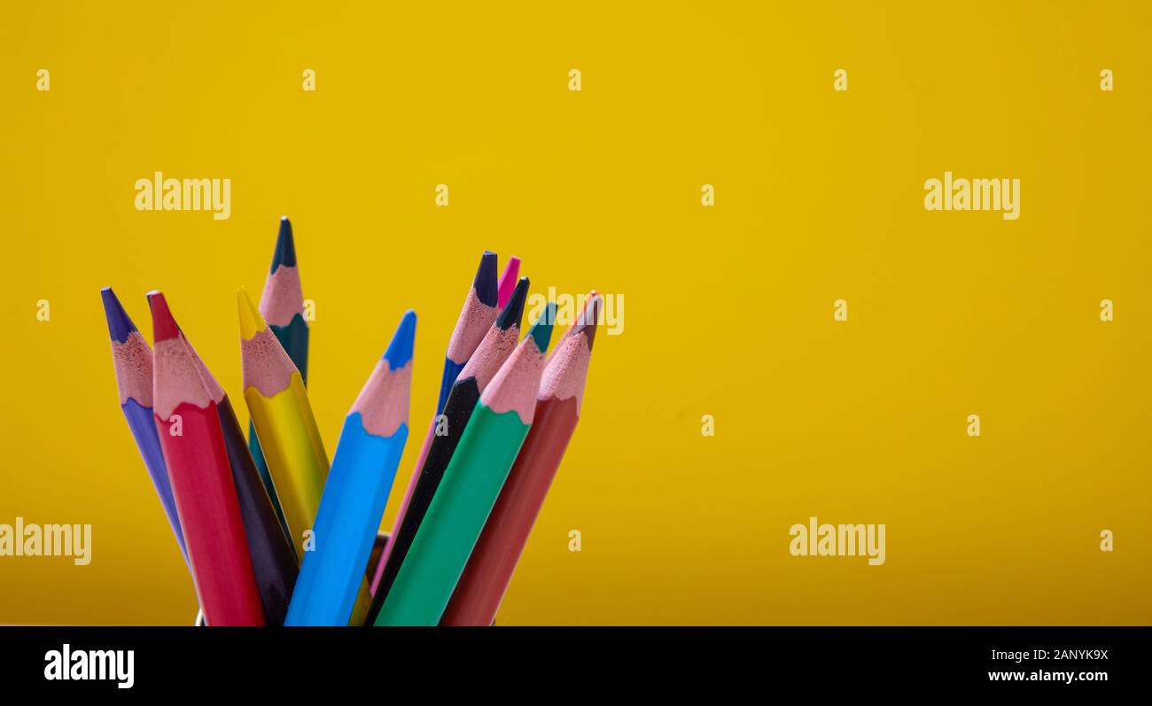 School, drawing, creativity concept. Colored pencils on yellow background. Copy space Stock Photo