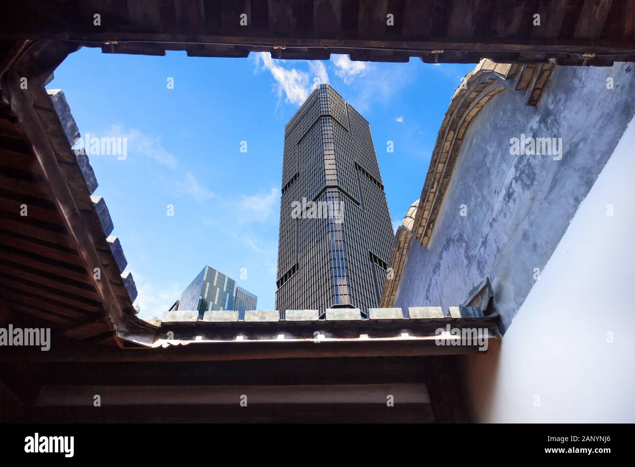 Upward view of  the skyscrapers with blue sky background from a Chinese traditional courtyard,China Stock Photo