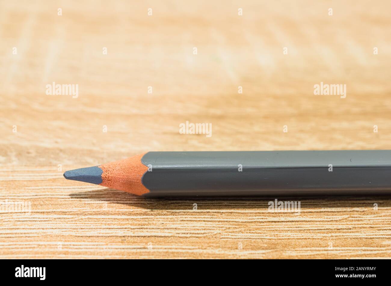 Closeup shot of a grey pencil on a wooden surface Stock Photo