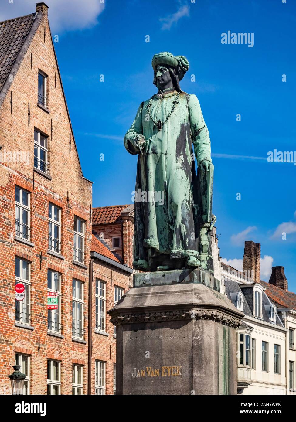25 September 2018: Bruges, Belgium - Statue of the 15th century painter, Jan van Eyck, standing in the square which bears his name in Bruges. Stock Photo