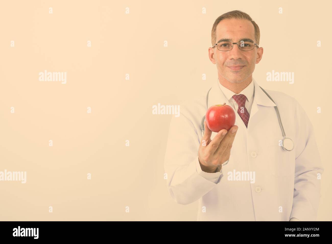 Portrait of mature handsome Persian man doctor Stock Photo - Alamy