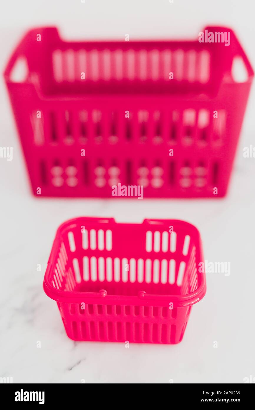big vs small budget conceptual still-life, different size shopping baskets  next to each other Stock Photo - Alamy