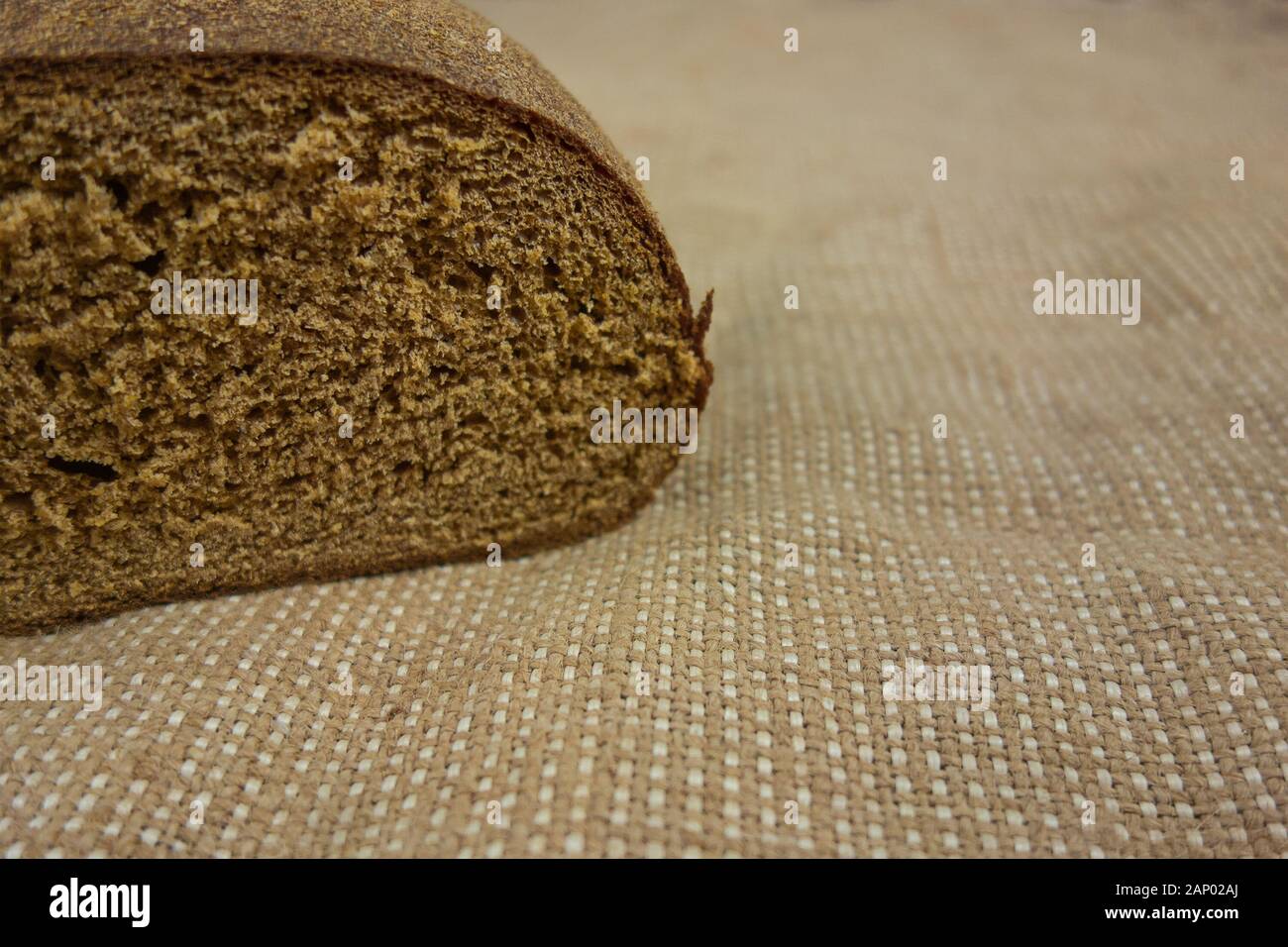 Brown bread on bagging fabric. Closeup view of whole wheat rye bread ...