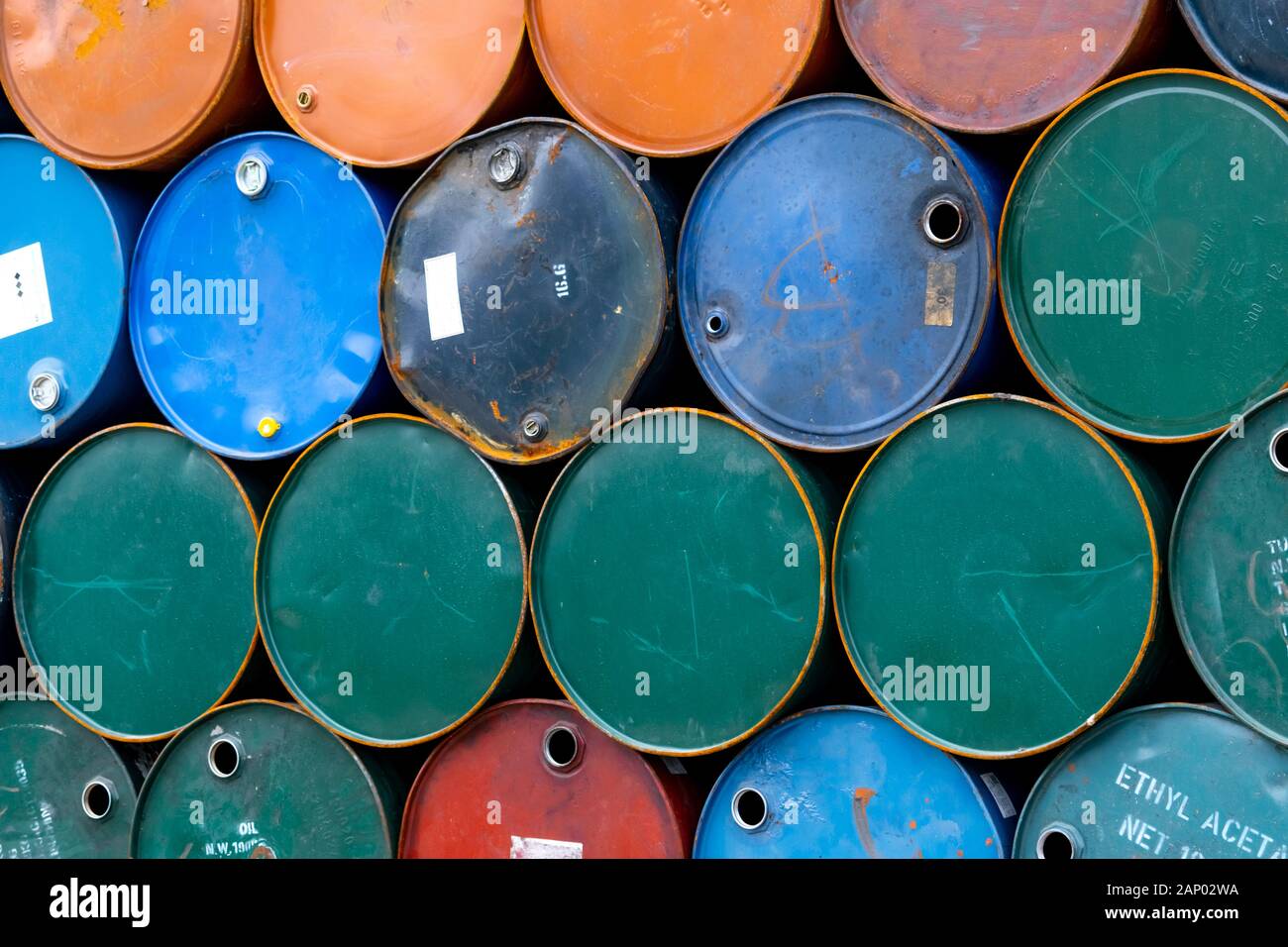 Old chemical barrels. Blue, green, and red oil drum. Steel oil tank