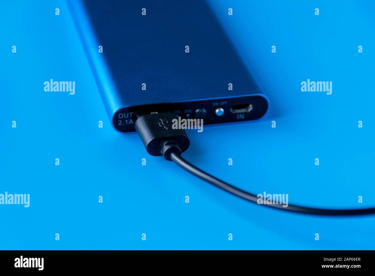 Power bank for charging mobile devices and devices. Blue smartphone ...