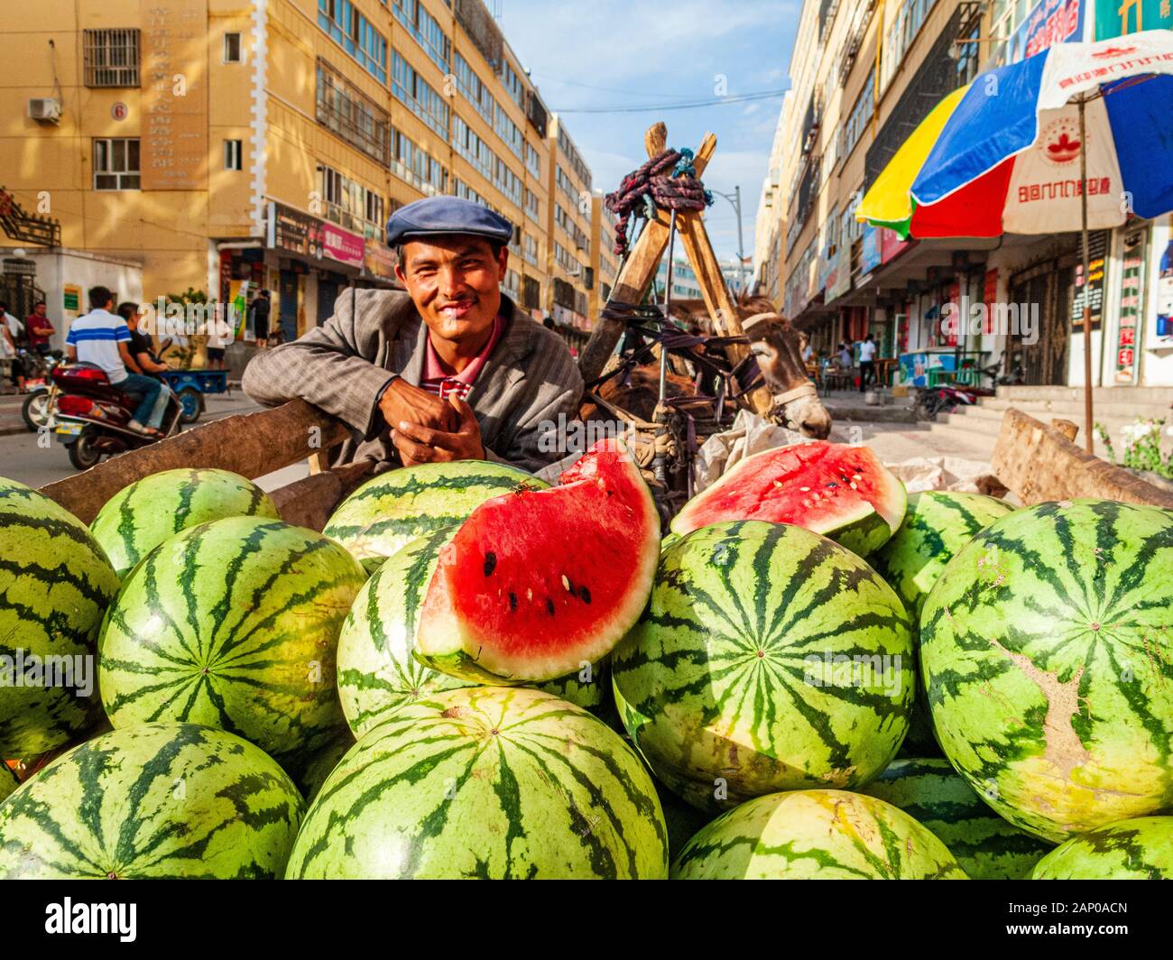 Fruit Sellers selling melones in the streets of the destroyed old part of the Oasis Stock Photo