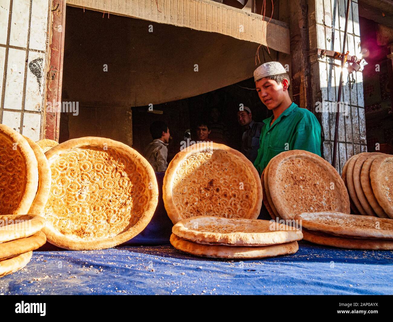 Uigur bread is made in a tandoori oven and sold in the streets of the destroyed old part of the Oasis Stock Photo