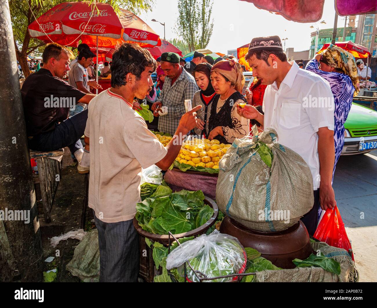 Vendors selling fruits and vegetables in the streets of the destroyed old part of the Oasis Stock Photo