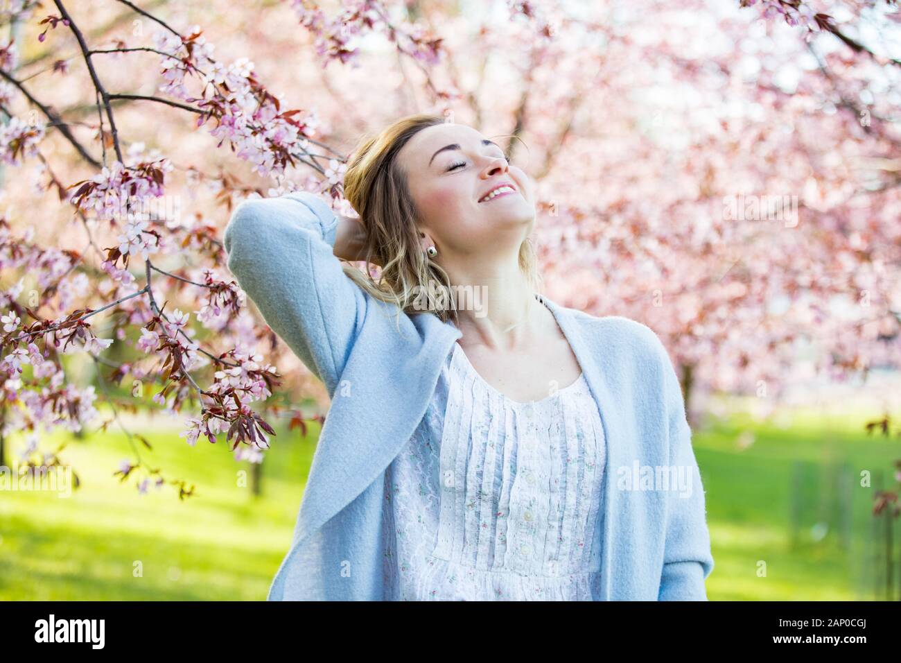 Enjoying Spring Young woman enjoying the nature in spring. Dancing, running and ...