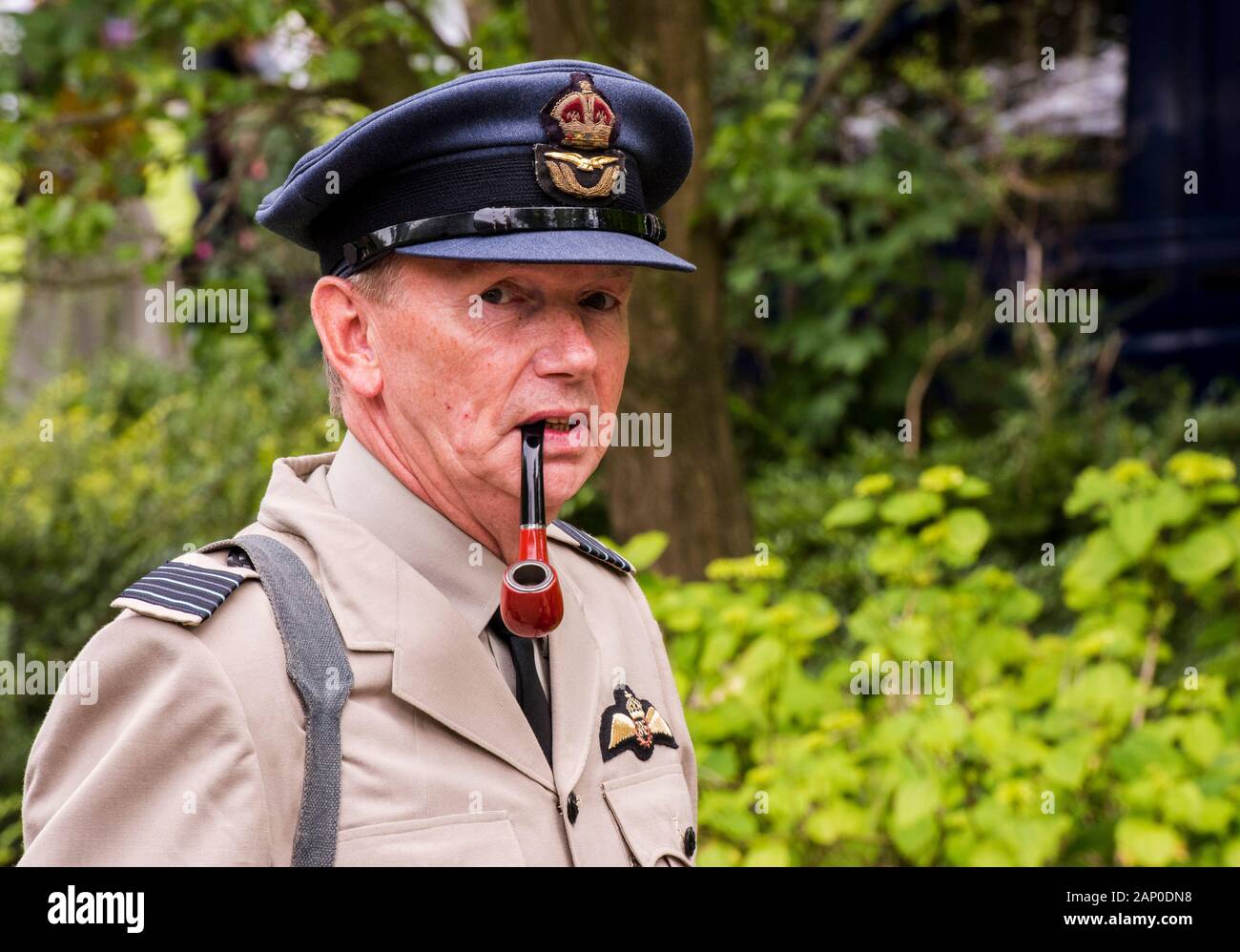 Man in military uniform smoking pipe in Valley Gardens on 1940s Day in Harrogate in England. Stock Photo