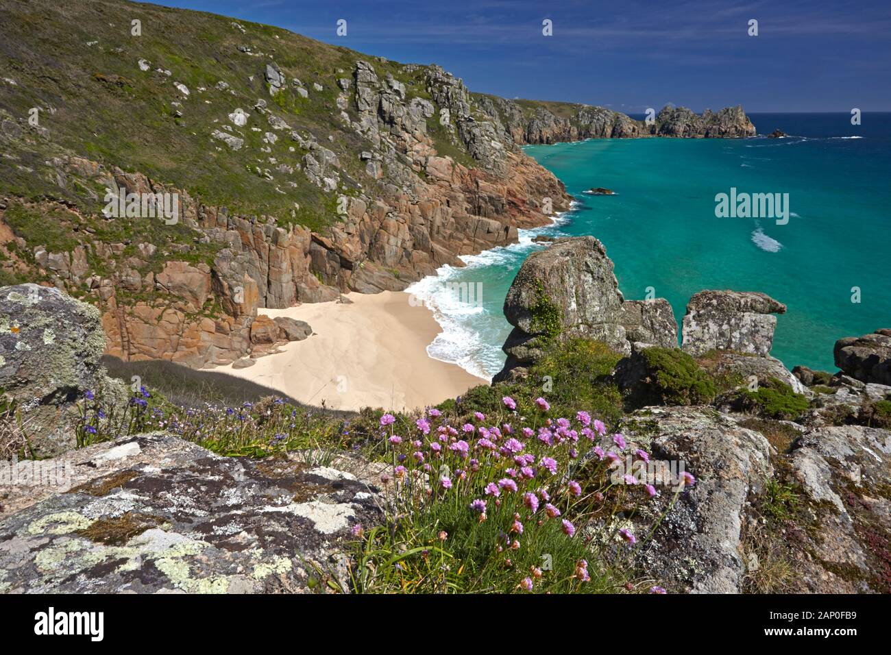 View from the clifftop to the golden sand and turquoise sea of Pednvounder Beach and Treen Cliffs. Stock Photo
