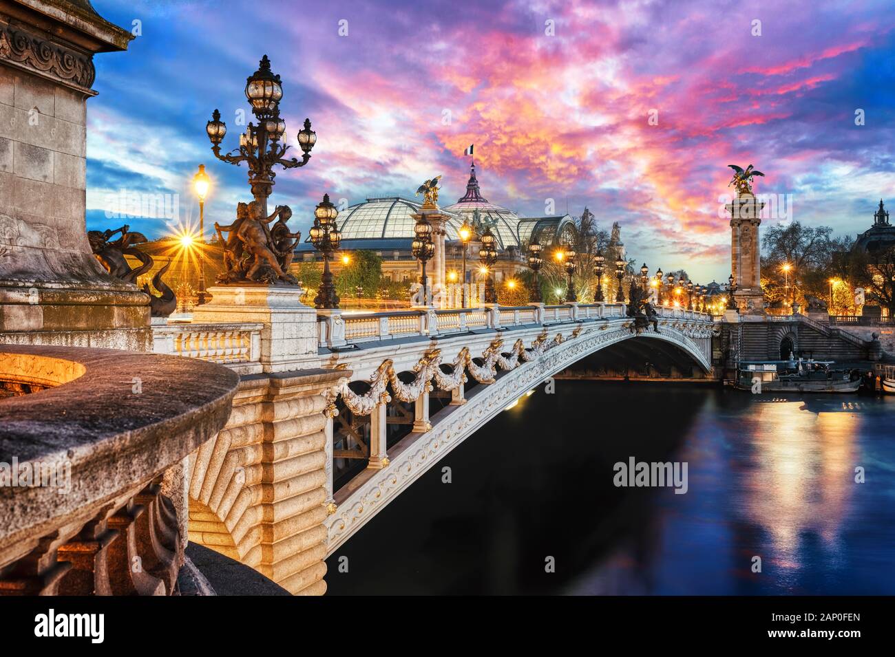 The Alexander III Bridge across Seine river in Paris, France at sunset. Stock Photo