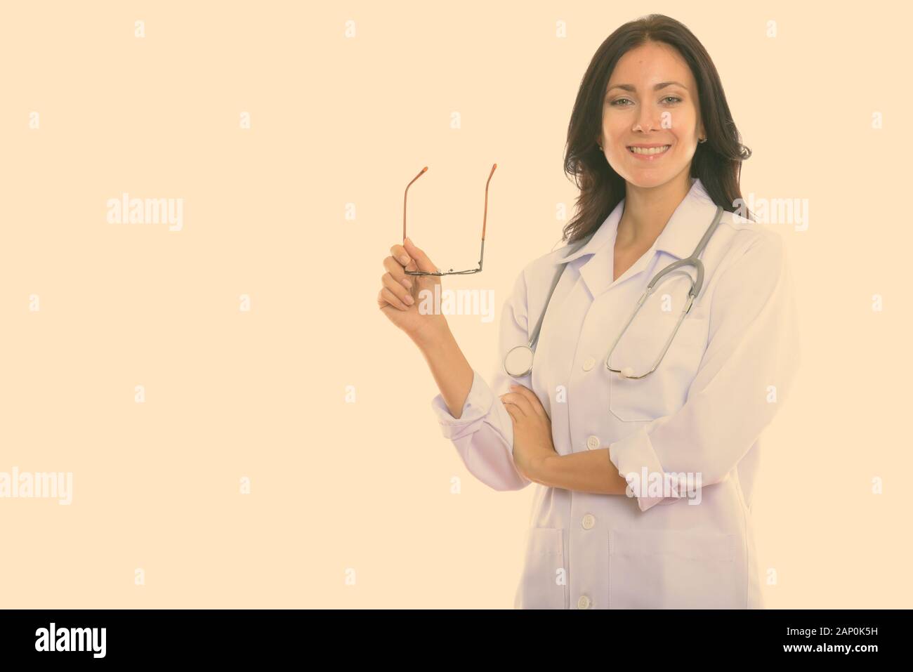 Studio shot of young beautiful woman doctor isolated against white ...