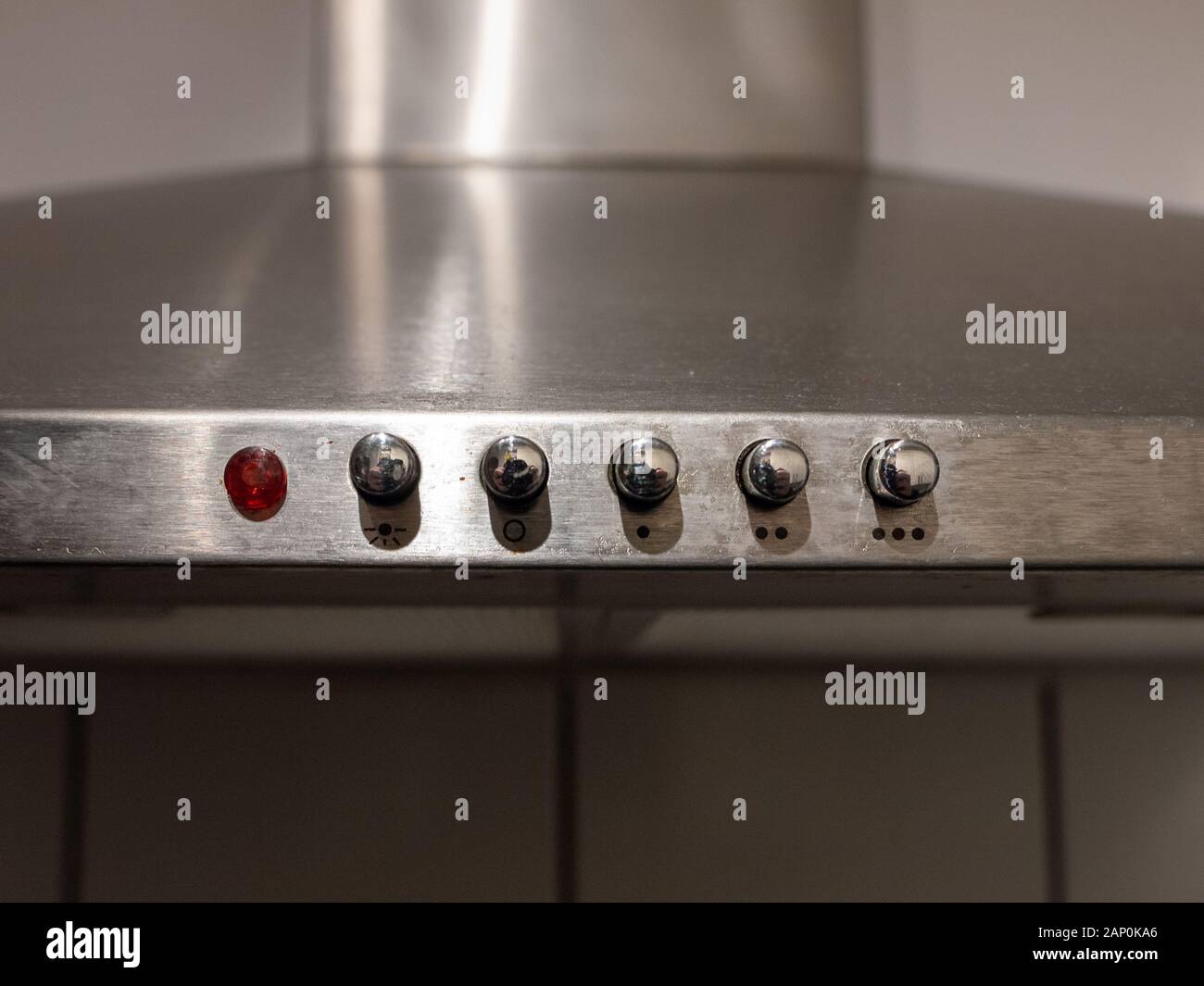 Metallic buttons atop kitchen stove close up; England; UK Stock Photo