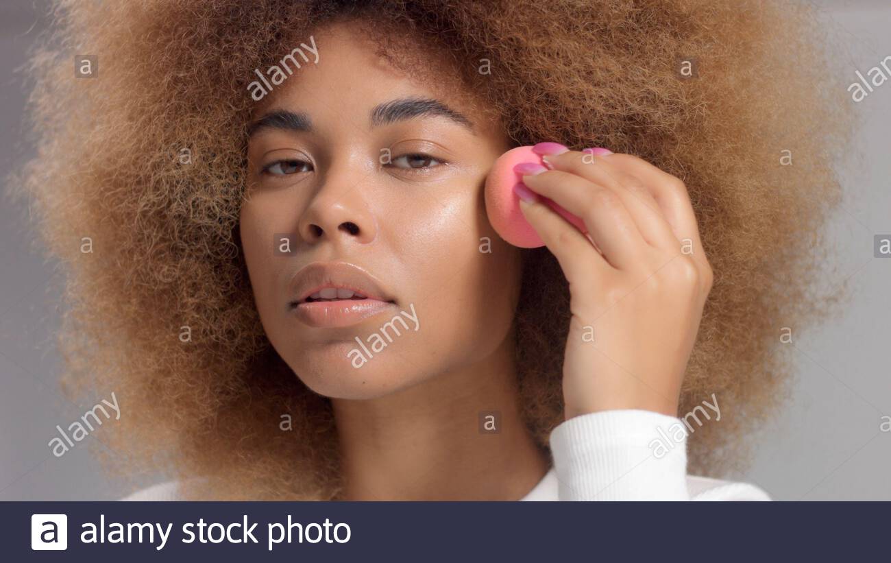 Mixed Race Black Woman With Big Afro Hair In Studio Put A Facial