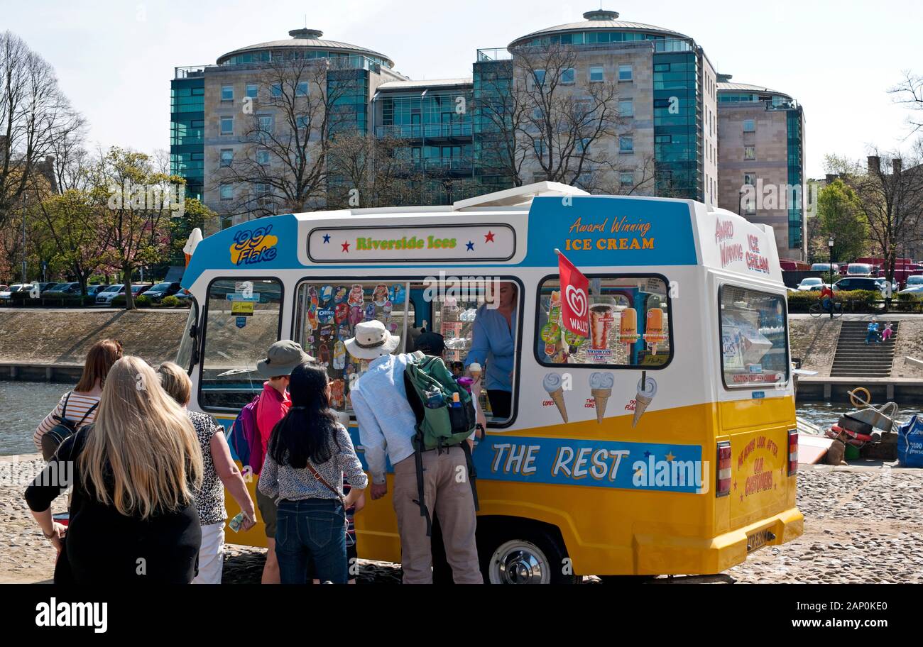 People queuing for ice creams from a traditional ice cream van on a sunny day. Stock Photo