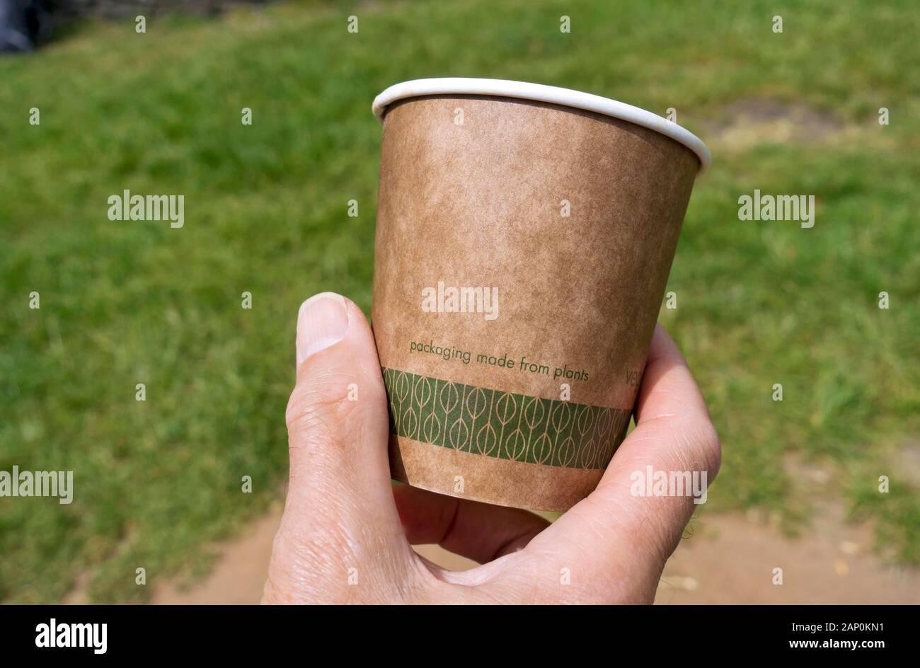 Close up of hand holding drinking cup made from plants. Stock Photo