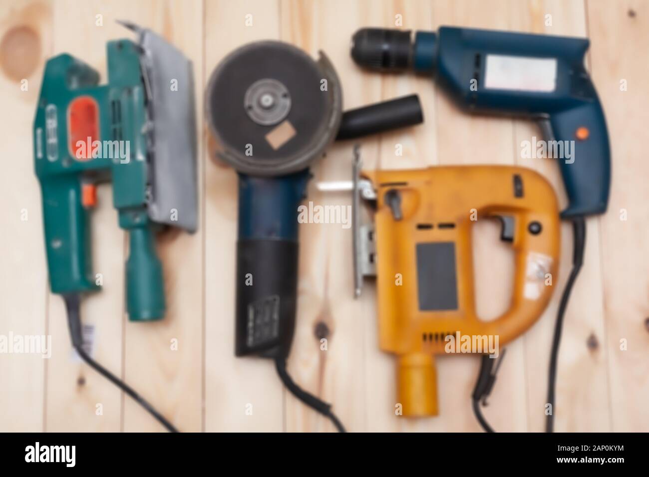 Set of construction tools on a wooden background. Stock photo out of focus assortment of electric tools. Stock Photo