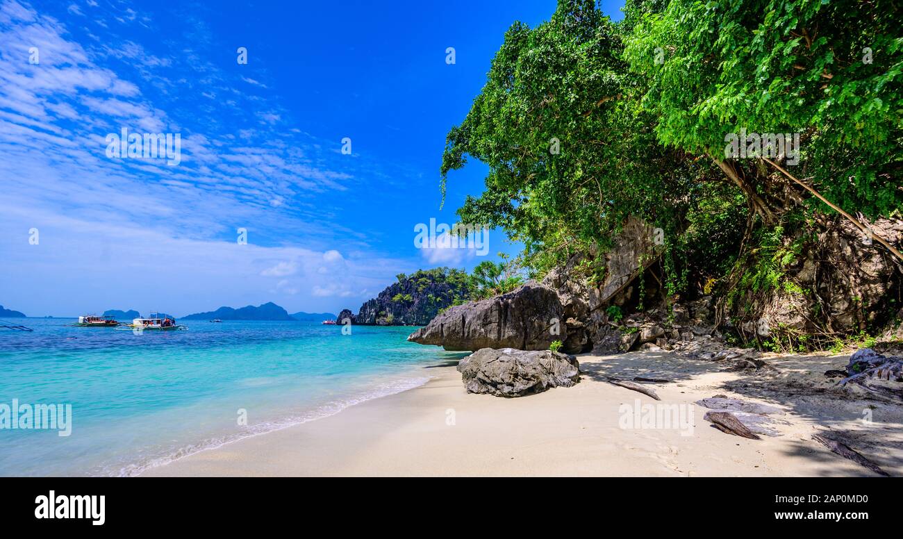 Tropical Papaya beach at paradise coast, El Nido, Palawan, Philippines. Tour A Route. Coral reef and sharp limestone cliffs. Stock Photo