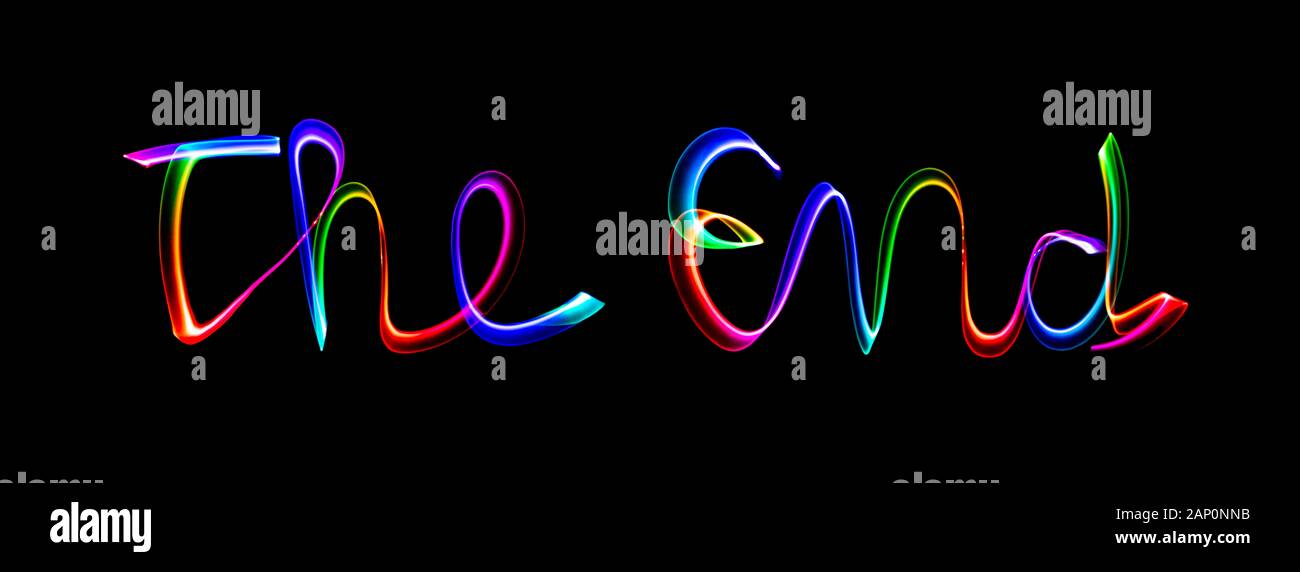 The End - coloured lettering made by writing in the air with a changing colour light wand. Stock Photo