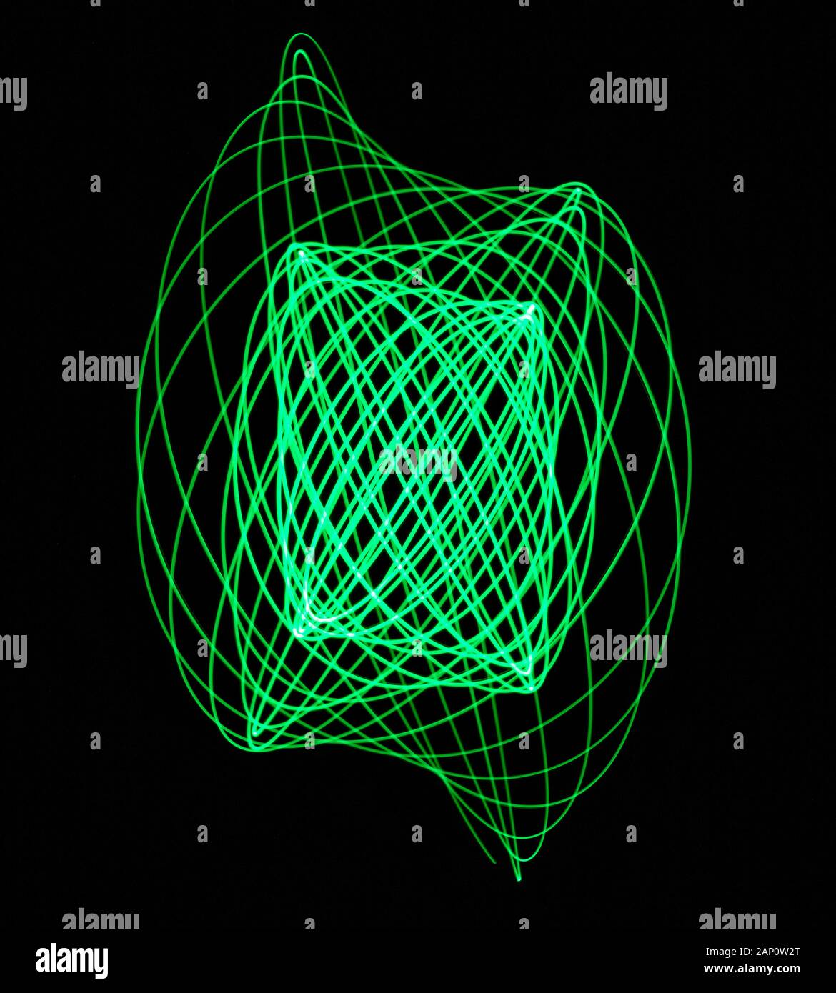 Light traces made with a moving light attached to a compound pendulum system to produce Lissajous figures. Stock Photo