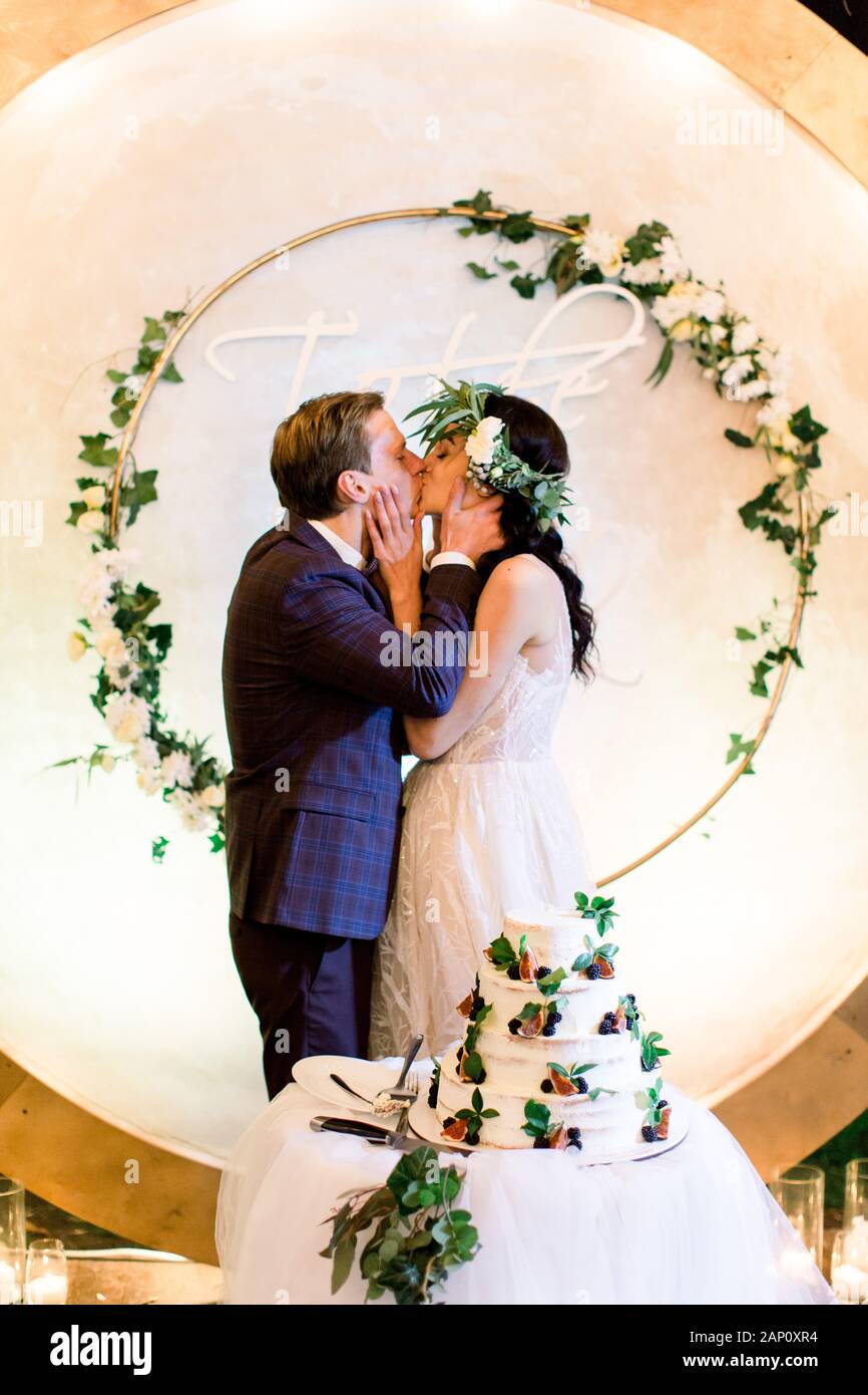 Bride And A Groom Kissing Standing Behind Their Rustic Wedding
