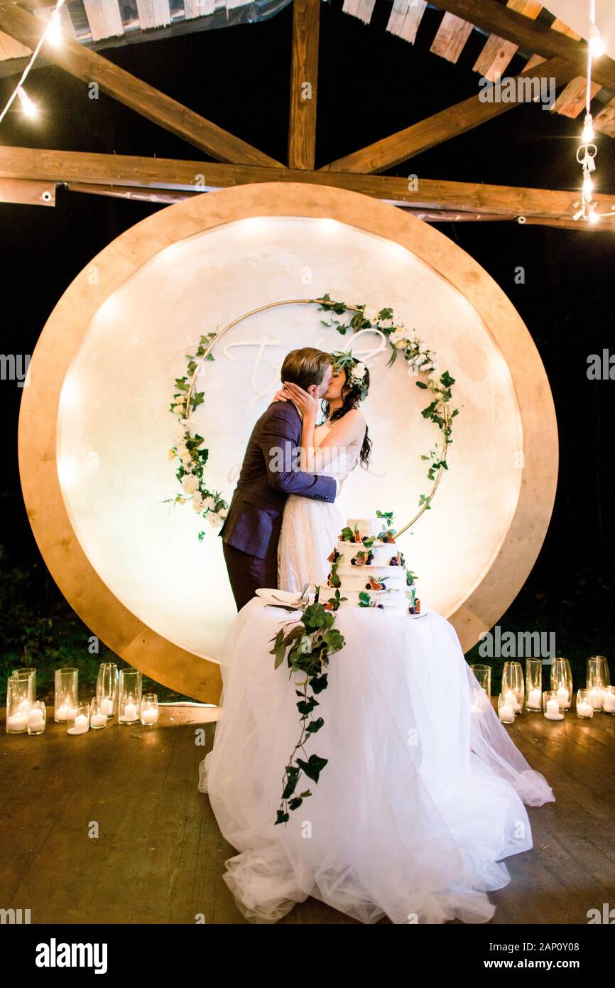 Bride And A Groom Kissing Standing Behind Their Rustic Wedding
