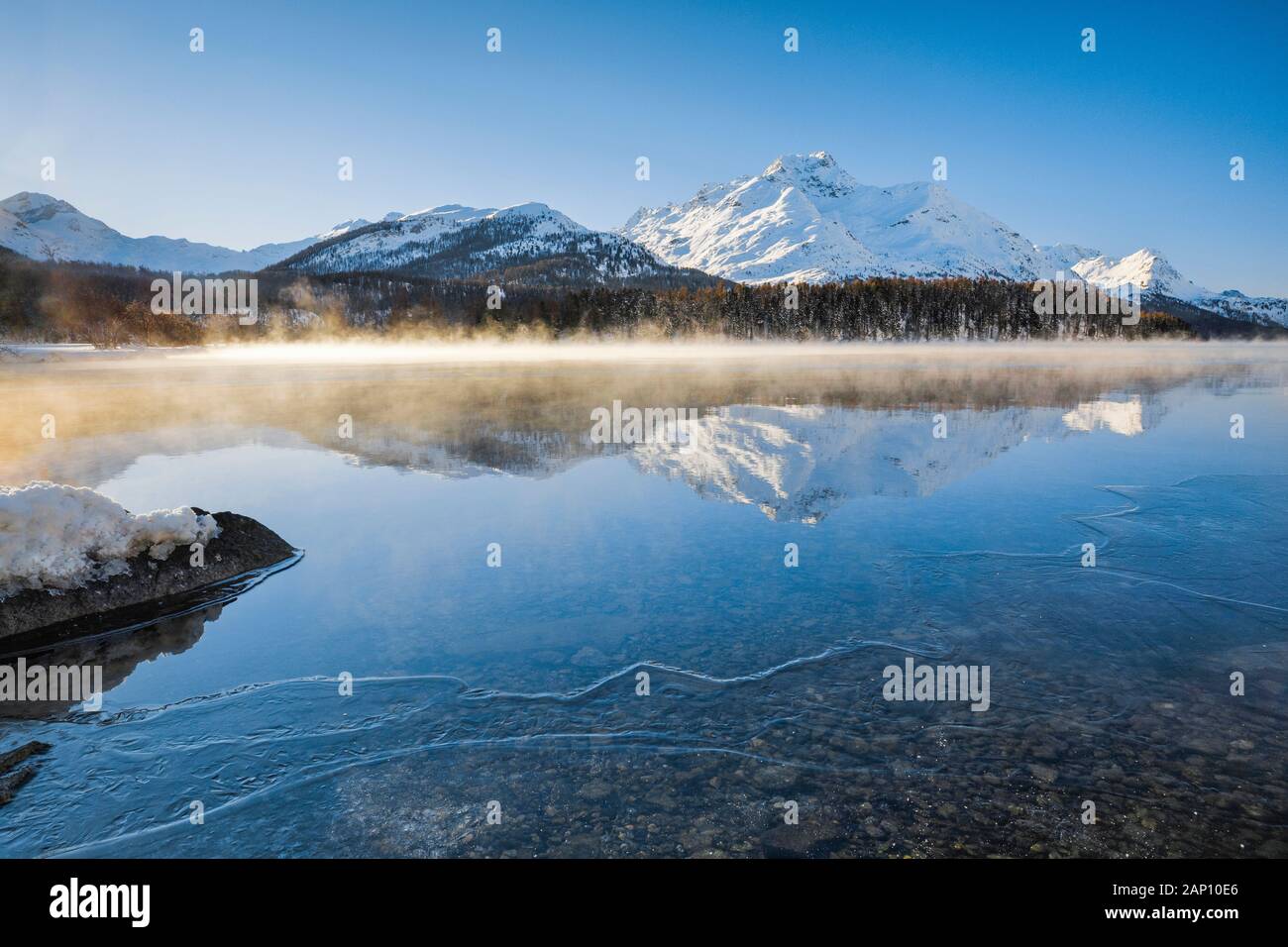 Lake Sils with the Piz da la Margna (3158 m) in winter with steam fog. Grisons, Switzerland Stock Photo