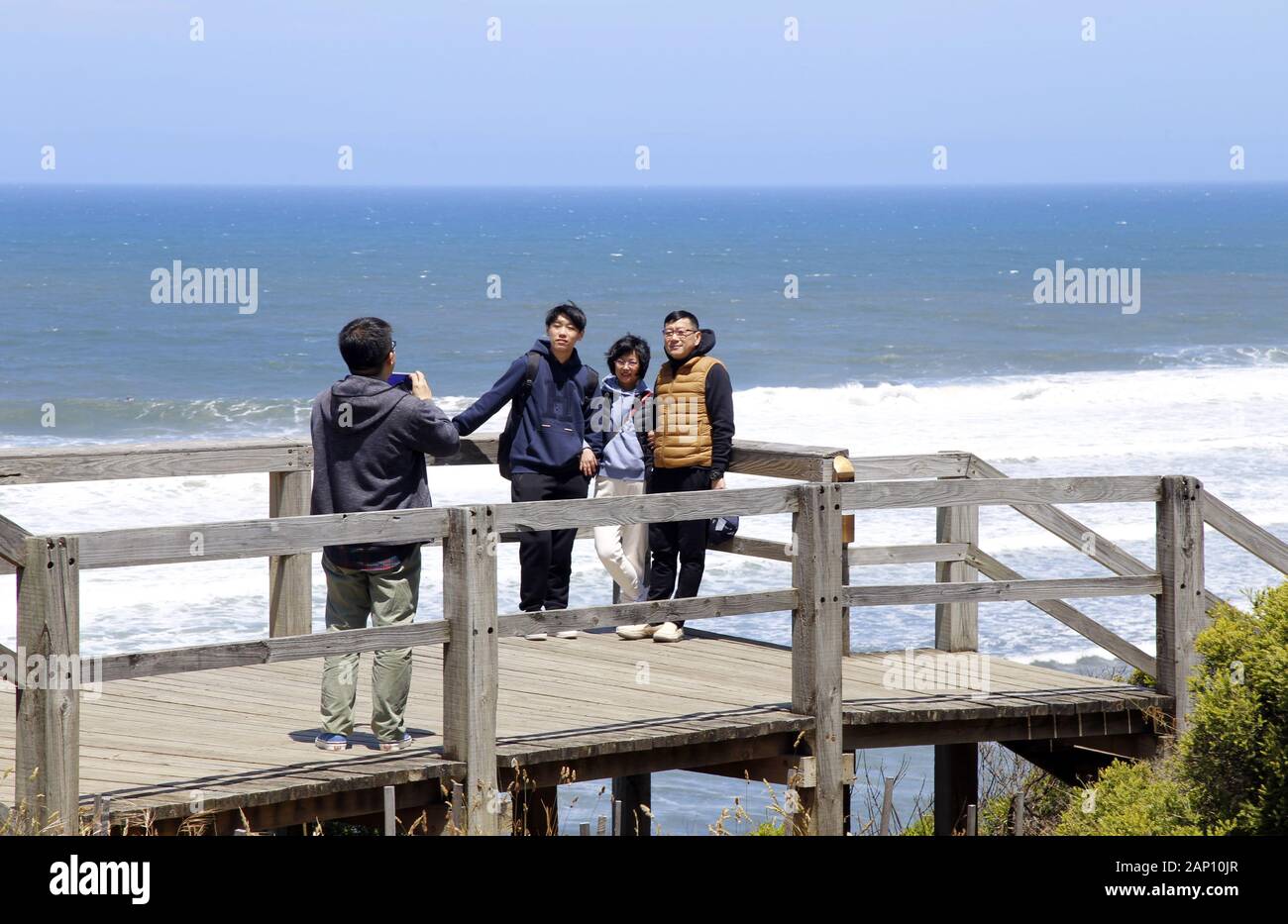 Asian tourist taking family portraits at Bell's Beach lookout near Torquay, Victoria, Australia Stock Photo
