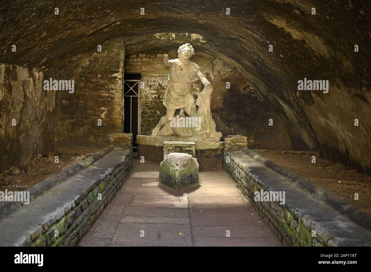 Rome. Italy. Ostia Antica. Mithraeum of the Baths of Mithras (Mitreo delle Terme del Mitra). Mithras about to kill the bull, cast of the original 1st Stock Photo